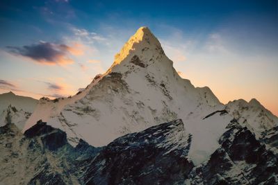 Scenic view of snowcapped mountains against sky during sunset