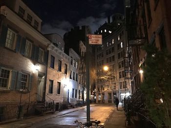 Illuminated city street at night