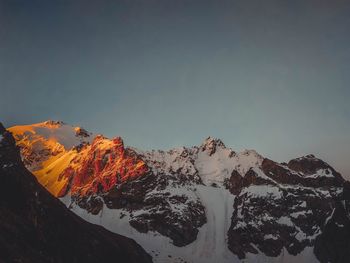 Scenic view of snowcapped mountain against sky during sunset