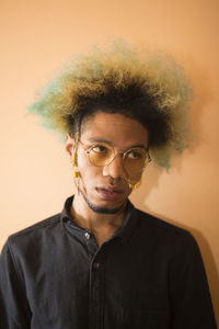 Portrait of young man against gray background