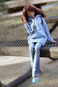 Low section of woman sitting outdoors