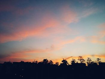 Silhouette of trees against sky at sunset