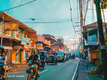 Street amidst buildings in city against sky