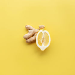 Close-up of lemon slice over yellow background