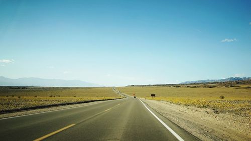 Country road against blue sky