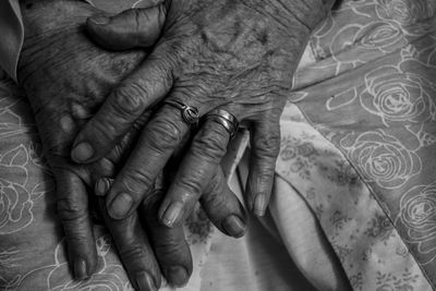 Close-up of woman hand with tattoo on bed