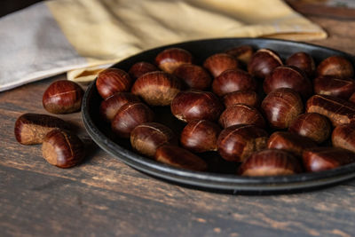 High angle view of roasted coffee beans in bowl on table