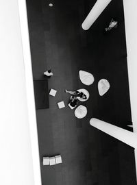 High angle view of man sitting in illuminated room