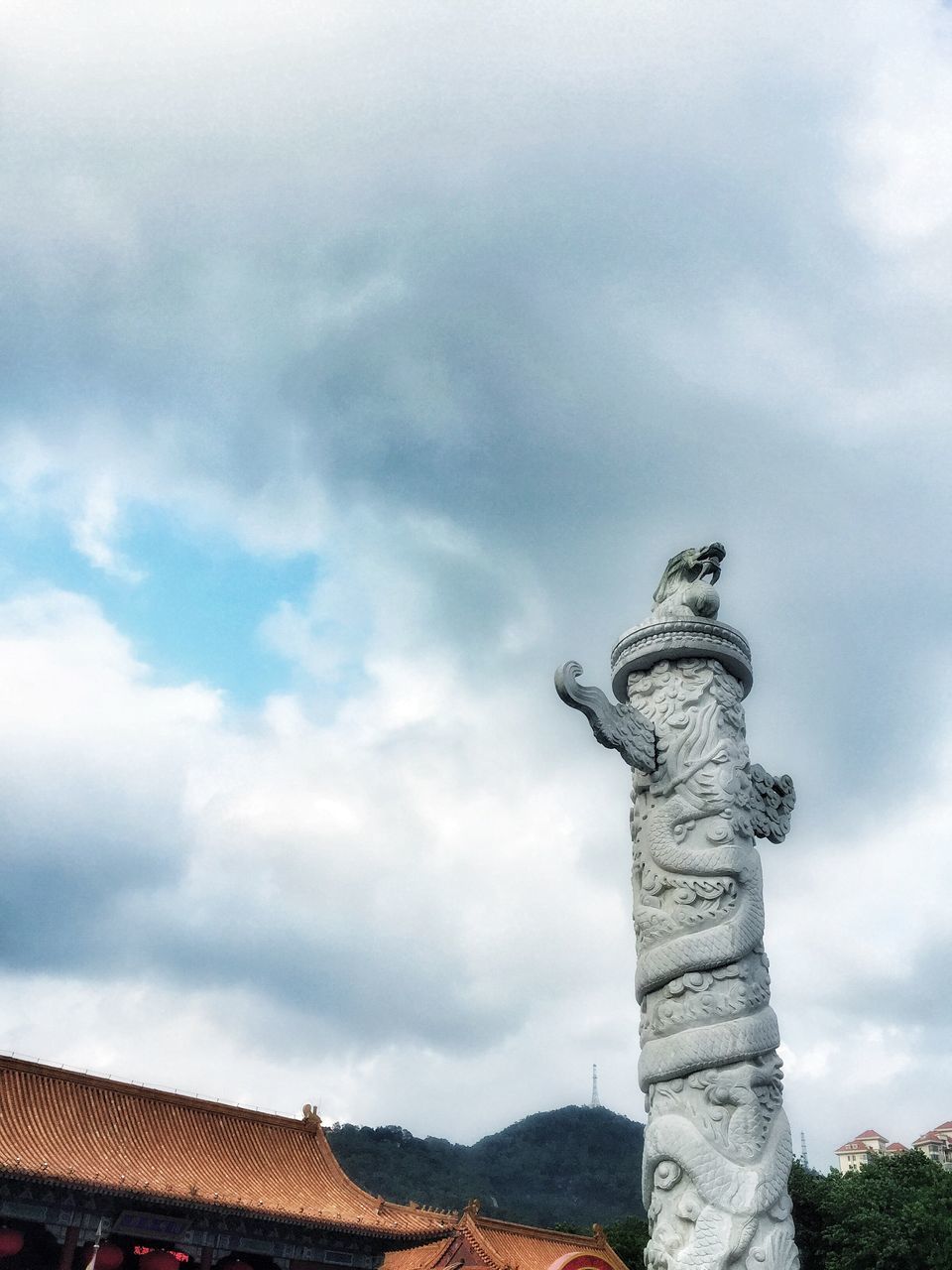 sky, architecture, built structure, cloud - sky, low angle view, cloudy, building exterior, cloud, history, sculpture, statue, art and craft, art, architectural column, day, no people, overcast, outdoors, creativity, human representation