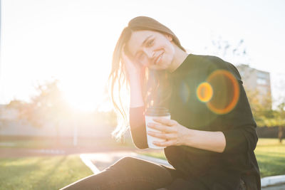 Portrait of smiling young woman using mobile phone