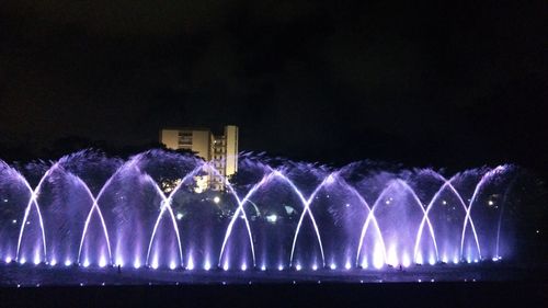 Illuminated fountain at night