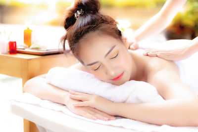 Smiling woman receiving massage at spa