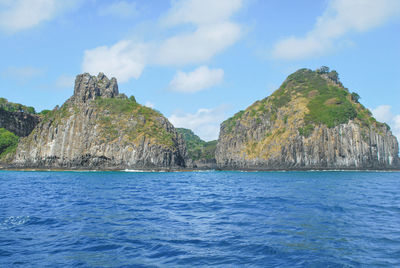 Scenic view of sea and rock formation against sky