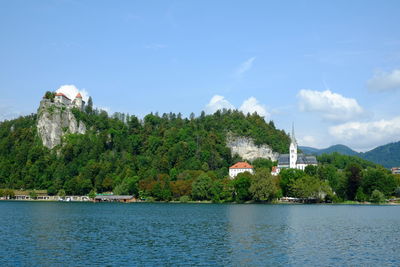 Scenic view of sea by buildings against sky