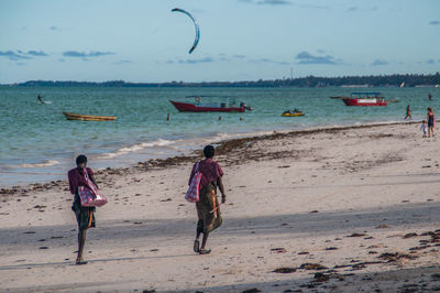 Rear view of people on beach