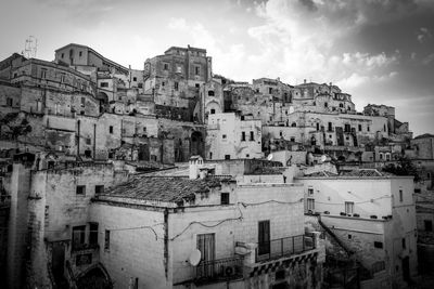 High angle view of old buildings in town against sky