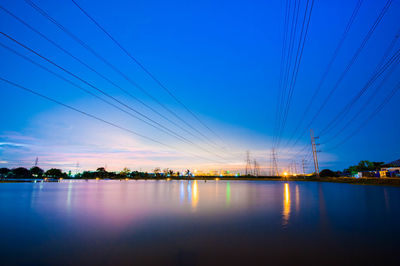 Scenic view of illuminated city against sky at dusk