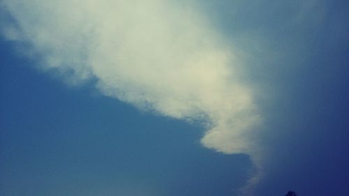 Low angle view of vapor trail in blue sky