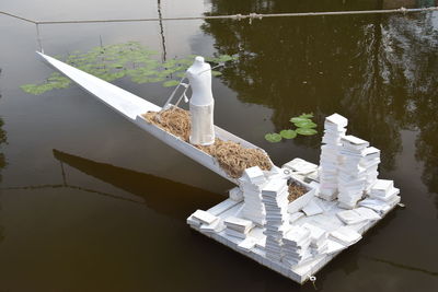 High angle view of white paper on table by lake