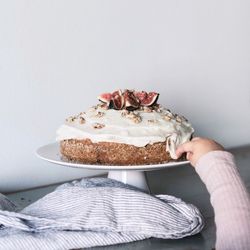 View of young girl tasting icing from cake