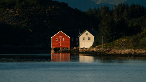 Scenic view of houses at the sea against sky