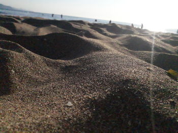Surface level of sandy beach against sky