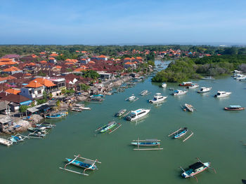High angle view of buildings by sea against sky