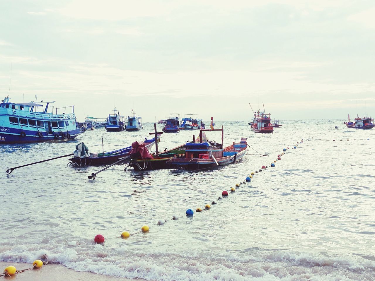 sea, water, nautical vessel, transportation, sky, mode of transport, boat, cloud - sky, moored, cloud, horizon over water, beach, nature, day, tranquility, cloudy, incidental people, tranquil scene, scenics, beauty in nature