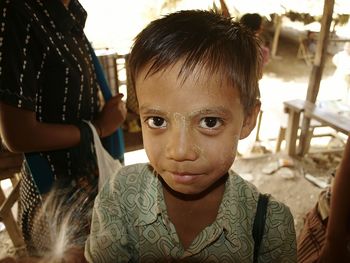 Close-up portrait of boy standing outdoors