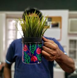 Midsection of woman holding plant