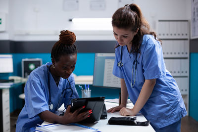 Side view of doctor examining patient in office