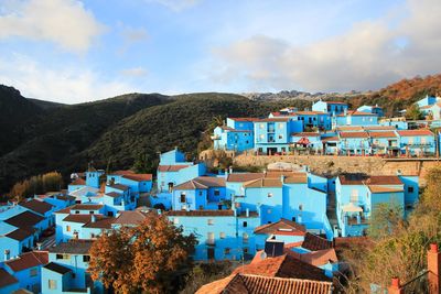 High angle view of houses in town against sky