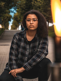 Portrait of young woman sitting outdoors