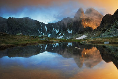 Scenic view of lake and mountains against sky