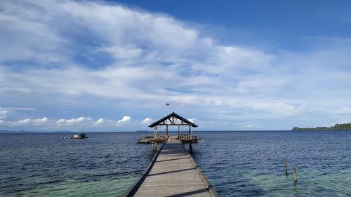 Pier over sea against sky