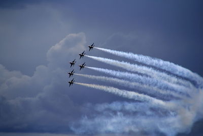 Low angle view of airplane flying against sky