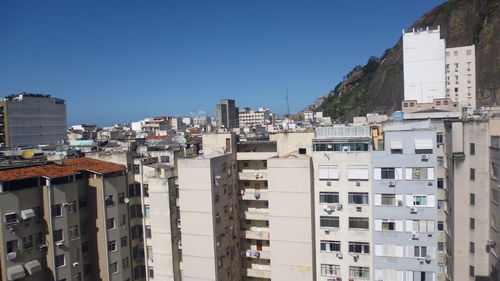 Cityscape against clear blue sky