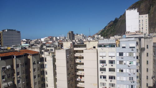 Cityscape against clear blue sky