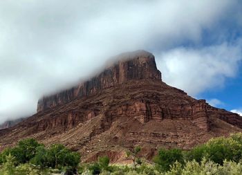 Low angle view of rock formation against sky