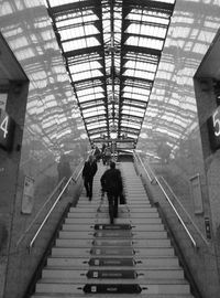 Full length of woman walking on escalator