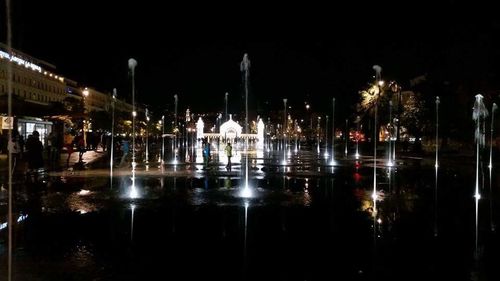 Reflection of buildings in water at night