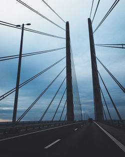 Low angle view of suspension bridge against sky