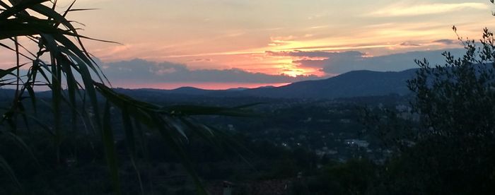 Scenic view of mountains against sky at sunset