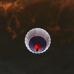 Low angle view of hot air balloon flying against cloudy sky during sunset