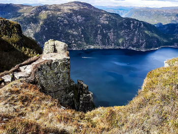 High angle view of lake and mountains against sky
