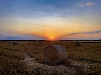 Hay bales at sunset