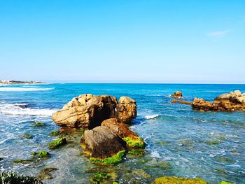 Scenic view of sea against clear blue sky