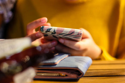 Close-up of woman hand on table