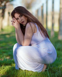 Young woman sitting on field