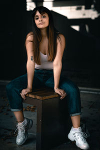 Portrait of a young woman sitting on seat